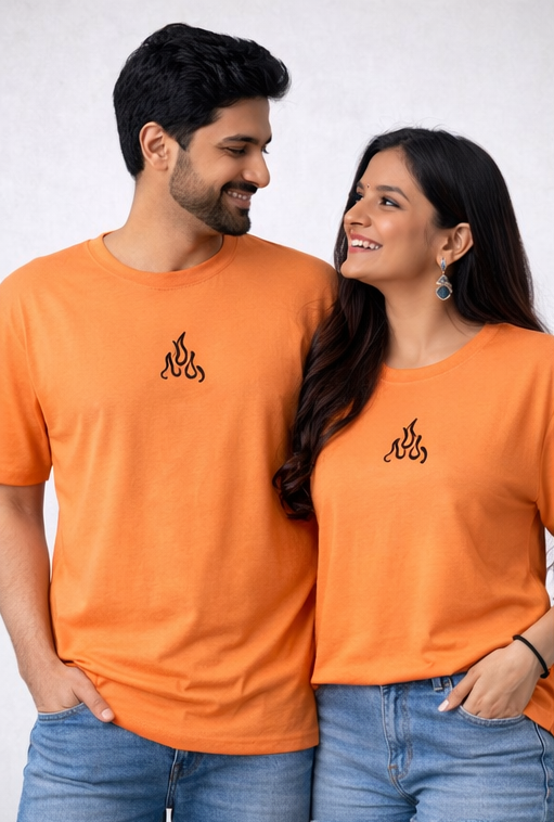 Two people wearing orange t-shirts with a logo, posing against a white background.