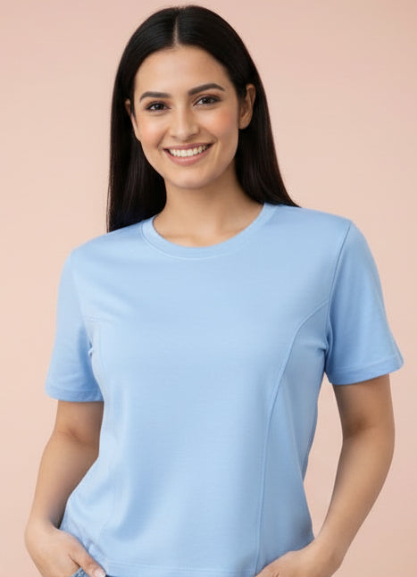 Woman wearing a light blue t-shirt and denim shorts in four different poses on a white background